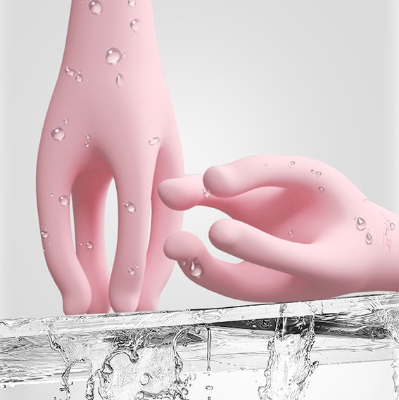 Pink human hand exterior massage nipple stimulator in contact with water