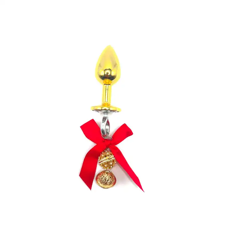 Gold-colored metal anal butt plug with a bell
